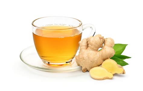 Glass cup of hot ginger tea with ginger rhizome sliced isolated on white background | Premium Photo