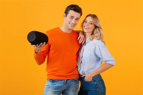 Free Photo Beautiful Smiling Young Couple Holding Wireless Speaker