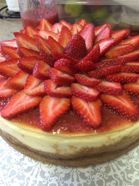 New York Cheesecake Topped With Fresh Strawberry Sauce And Garnished