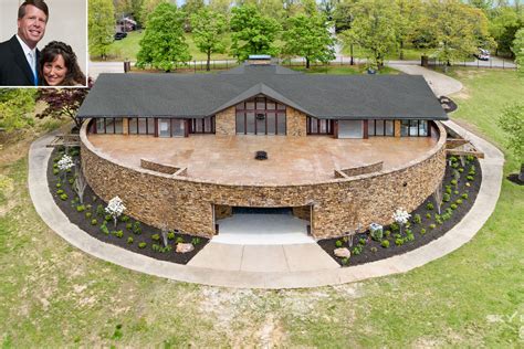 an aerial view of a house with a woman in the front yard and a man ...