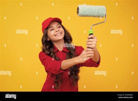 Positive And Smiling Builder In Building Uniform And Cap Painter