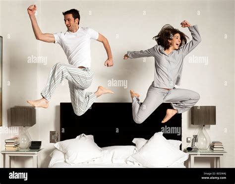 couple leaping out of bed Stock Photo - Alamy