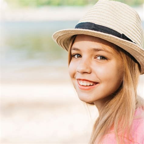 Free Photo | Smiling girl in hat at shore