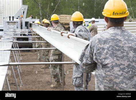 Soldiers From The 902nd Engineer Company 15th Engineer Battalion Load