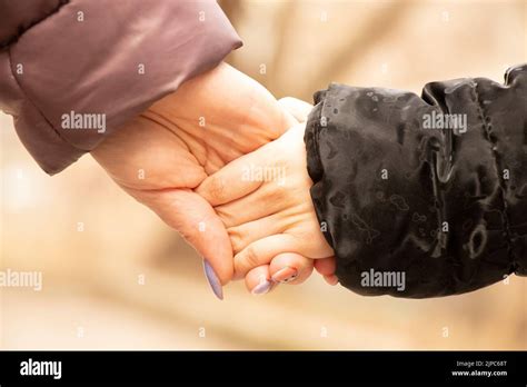 Ukrainian Mother And Daughter Hold Hands On The Street During The War