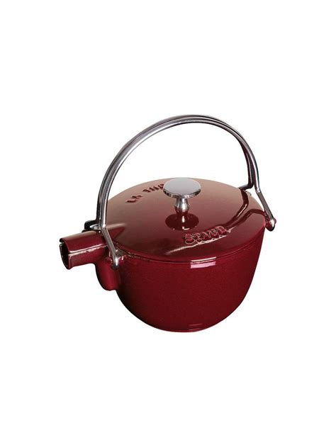 A Red Casserole With A Handle Is Shown On A White Background And Has