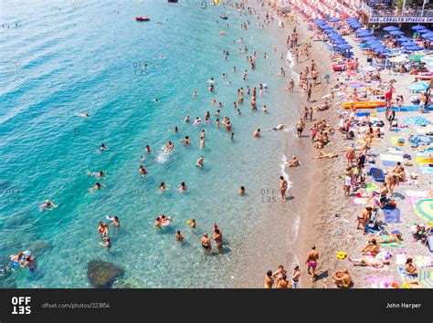 Salerno, Italy - August 13, 2015: Beach goers on coastal Italy stock photo - OFFSET