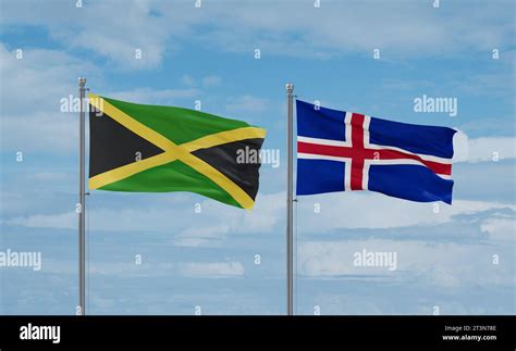 Iceland And Jamaica Flags Waving Together In The Wind On Blue Cloudy