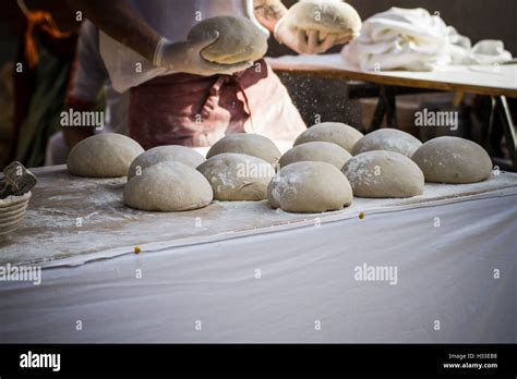 Baker making artisan bread in a medieval fair Stock Photo - Alamy