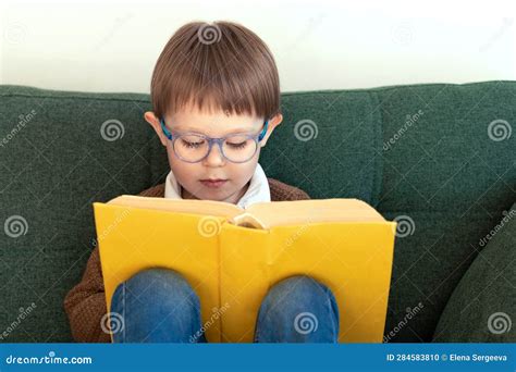 Child Reads A Book Smart Boy Wears Glasses Stock Photo Image Of