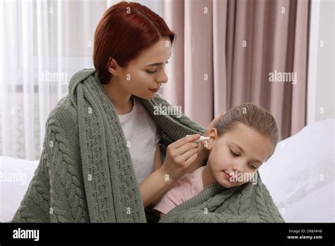 Mother Dripping Medication Into Daughters Ear While Being Wrapped In