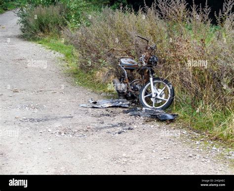 Stolen Burned Out And Abandoned Motorcycle In The Countryside Stock