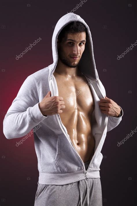 Handsome Fitness Man Showing Six Pack Abs On A Dark Background Stock