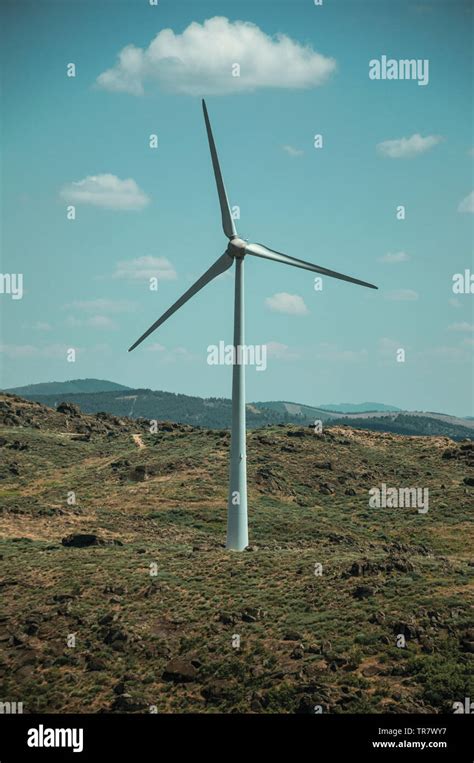 Wind Turbine For Electric Power Generation Over Hilly Landscape At