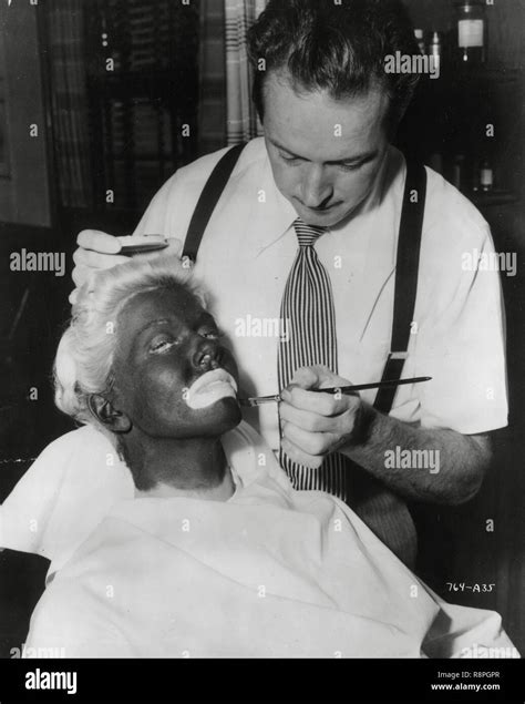 Doris Day, during a makeup session, applying black-face minstrel makeup ...