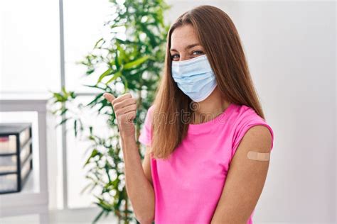 Young Woman Getting Vaccine Showing Arm With Band Aid Smiling Happy And