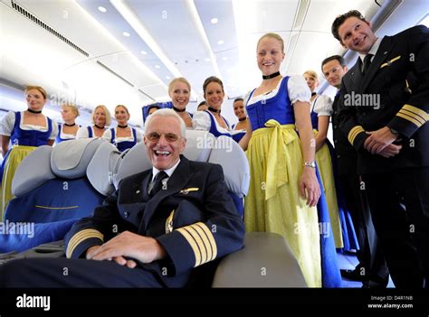 Captain Markus Koch And Lufthansa S Trachtencrew In A Plane At The