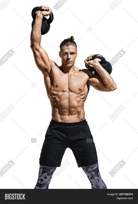 Sporty Man Training With Kettlebells Photo Of Sporty Model With Naked