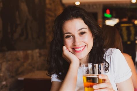 Premium Photo Close Up Portrait Of Young Woman Holding Beer In Restaurant