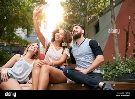 Group Of Smiling Friends Taking Selfie With Smart Phone Multiracial