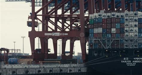 Panning With A Large Shipping Container That Is Being Unloaded Off A