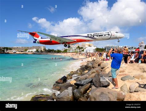 PAWA Dominicana MD-83 plane extreme low approach over Maho Beach, St. Maarten. Tourist ...