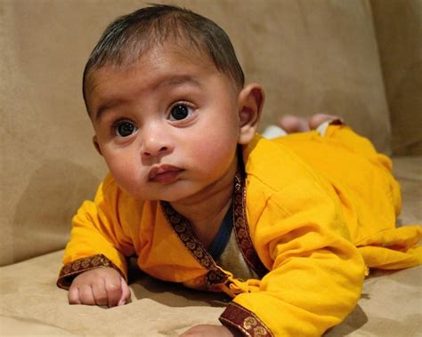 Premium Photo Cute Baby Lying On Sofa At Home