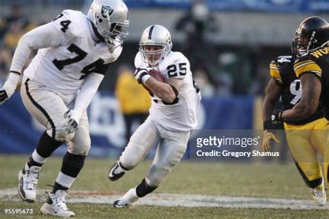 Justin Fargas of the Oakland Raiders carries the ball as Cornell ...