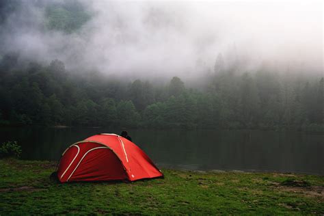 Camping by Foggy Forest in Red Tent Royalty-Free Stock Photo