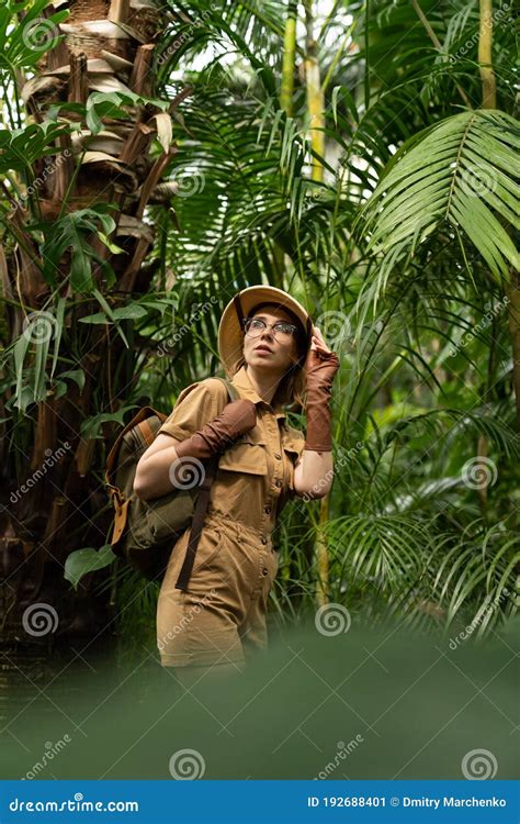 Woman Botanist In Greenhouse Naturalist With Backpack Walks In The