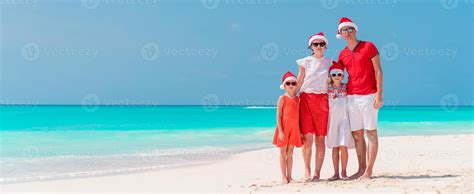 Happy family on the caribbean beach celebrating Christmas vacation ...