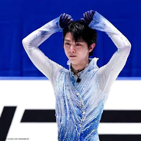 A Man With His Hands On His Head Standing In Front Of An Ice Skating Rink