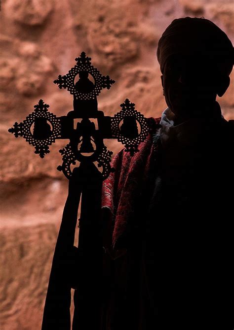 Ethiopian Orthodox Priest Holding A Cross During The Colorful Timkat