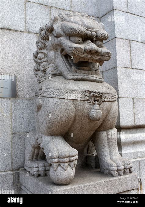 A Stone Chinese Lion Guarding The Bank Of China In Hong Kong Stock