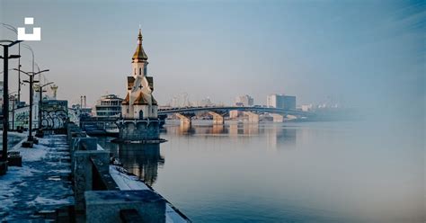 Brown And White Concrete Building Beside Body Of Water During Daytime Photo Free Tower Image