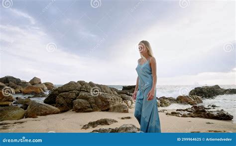 Sun Kissed Woman Strolls On Sandy Beach In Blue Dress Female Enjoys