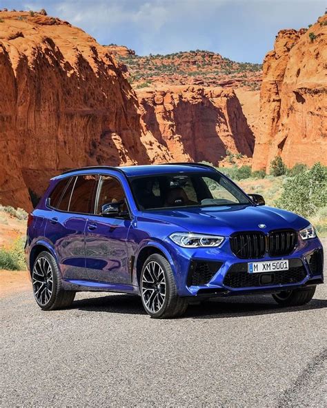 A Blue Bmw X5 Parked In The Desert