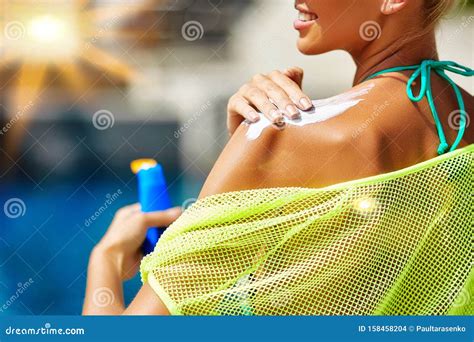 Woman Applying Sunscreen On Her Shoulder Stock Photo Image Of Bikini