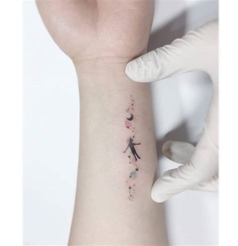 Peter Pan Tattoo Located On The Wrist Cartoon Style