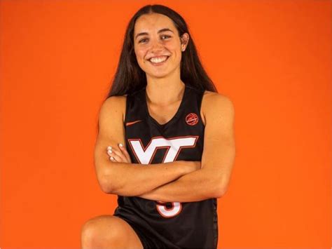 a female basketball player is posing for a photo with her arms crossed ...