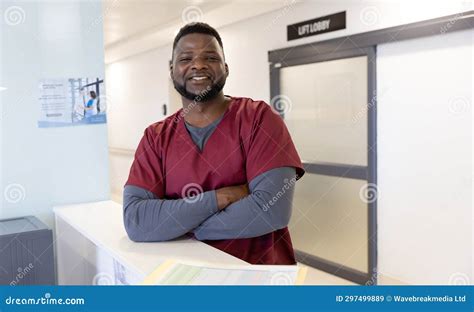 Portrait Of Happy African American Male Doctor In Hospital Reception