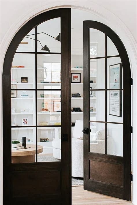 An Arched Glass Door Leading Into A Living Room