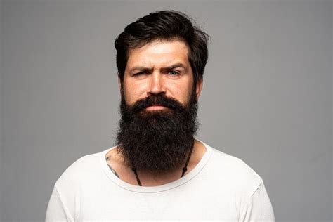 Premium Photo Portrait Of Confident Serious Man Has Beard And Mustache Looks Seriously