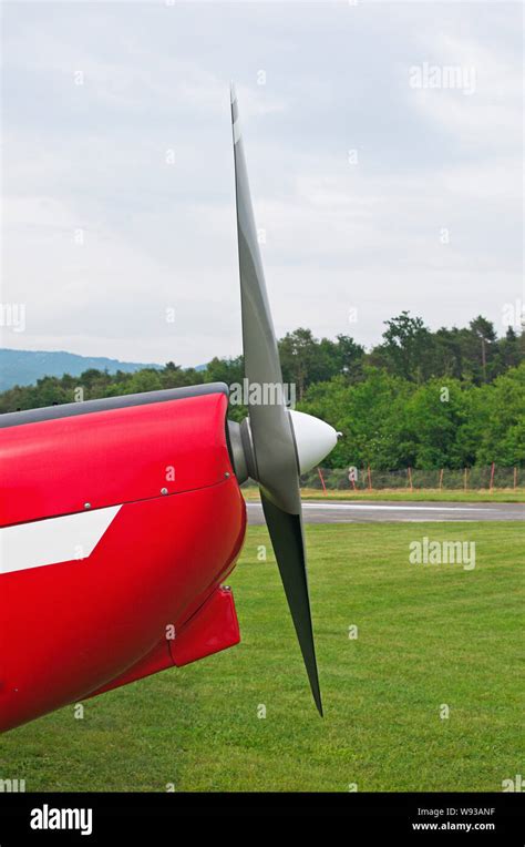 Side View Of A The Propeller Of A Light Aircraft Parked On Grass Stock