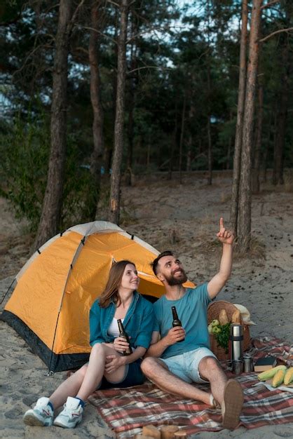 Couple Assis Levant Les Yeux Au Ciel Photo Gratuite