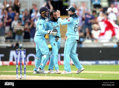 England's Adil Rashid celebrates taking the wicket of Australia's Pat Cummins, caught by Joe ...