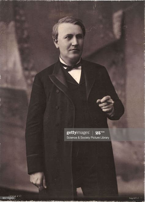 An Old Black And White Photo Of A Man In A Suit