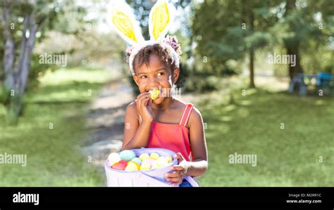 Cute And Beautiful African American Girl Wearing Bunny Ears Eats With