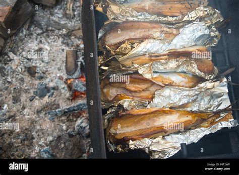 Smoked fish on fire Stock Photo - Alamy