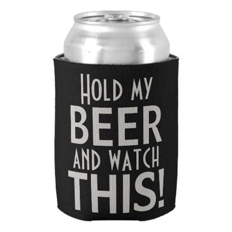 A Black Can Cooler With White Lettering That Says Hold My Beer And